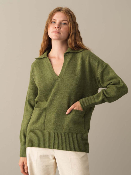 WOMAN IN GREEN RIBBED KNIT SWEATER